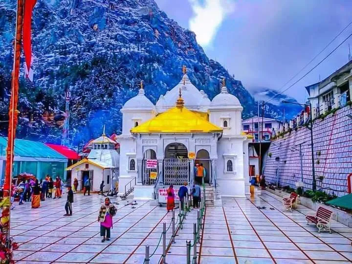 Gangotri temple at the source of holy Ganga river with devotees performing sacred rituals and prayers